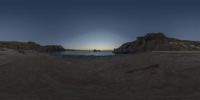 an 360 - pan picture taken at sunset on the beach with rocky formations in front