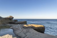 a long exposure photo of an outdoor beach area near the water on a sunny day