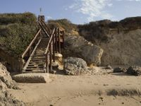 a stairway leads to the top of a mountain on a beach in california city, california