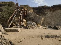 a stairway leads to the top of a mountain on a beach in california city, california