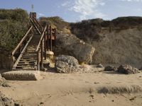 a stairway leads to the top of a mountain on a beach in california city, california