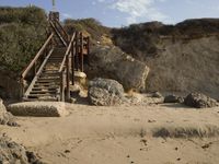 a stairway leads to the top of a mountain on a beach in california city, california