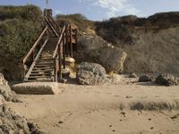 a stairway leads to the top of a mountain on a beach in california city, california