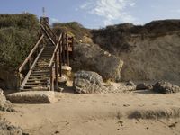 a stairway leads to the top of a mountain on a beach in california city, california