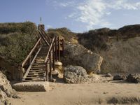 a stairway leads to the top of a mountain on a beach in california city, california