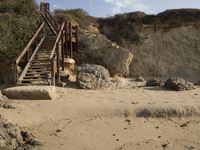 a stairway leads to the top of a mountain on a beach in california city, california