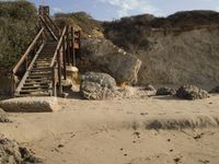 a stairway leads to the top of a mountain on a beach in california city, california