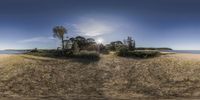 a sand and tree covered island at the ocean shore is seen through a 360 - eye lens