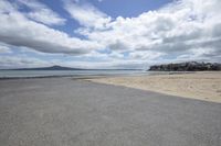 a view of a sandy beach, the tide is crashing and the shore is still dry