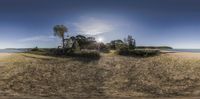 a sand and tree covered island at the ocean shore is seen through a 360 - eye lens