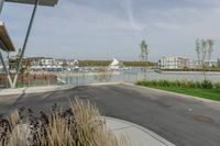 a city view across a lake and boats moored at dock and trees are in the background