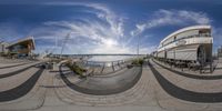 360 - fish - eye view of circular outdoor park and surrounding seating area, overlooking water