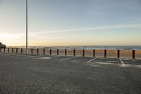 the parking lot has lines painted with chalk in it on a beach with a sky background