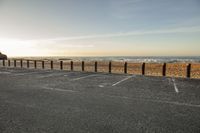 the parking lot has lines painted with chalk in it on a beach with a sky background
