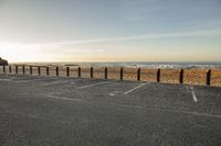 the parking lot has lines painted with chalk in it on a beach with a sky background