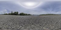 the view from the bottom of a parking lot of rocks and stones, a puddle of water in the middle