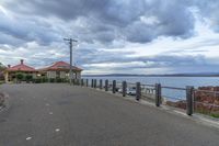 a small boat is sitting at the water's edge near a pier on a cloudy day