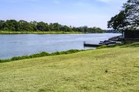 a view of a boat dock in a small area of grass next to the water