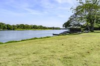 a view of a boat dock in a small area of grass next to the water