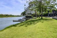 a view of a boat dock in a small area of grass next to the water