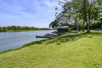 a view of a boat dock in a small area of grass next to the water