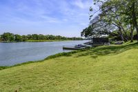 a view of a boat dock in a small area of grass next to the water