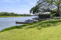 a view of a boat dock in a small area of grass next to the water