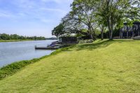 a view of a boat dock in a small area of grass next to the water