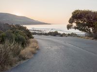 Coastal Road at Dawn: Leading to a Sandy Beach