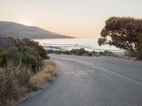 Coastal Road at Dawn: Leading to a Sandy Beach