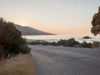 Coastal Road at Dawn: Leading to a Sandy Beach