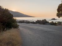 Coastal Road at Dawn: Leading to a Sandy Beach