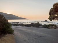 Coastal Road at Dawn: Leading to a Sandy Beach