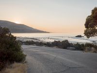 Coastal Road at Dawn: Leading to a Sandy Beach