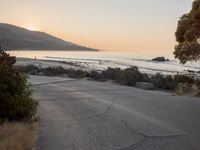 Coastal Road at Dawn: Leading to a Sandy Beach