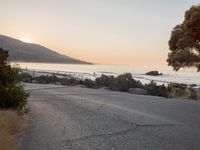 Coastal Road at Dawn: Leading to a Sandy Beach