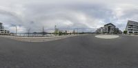 the view through a fish eye lens on the road where buildings are located is in the background