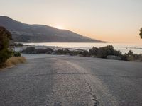Coastal Road at Dawn: Low Sunlight Illuminates the Landscape