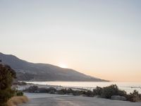 Coastal Road at Dawn: Low Sunlight Illuminates the Landscape