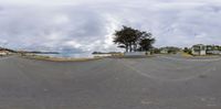 fisheye lens photograph showing a view of the sea and street at low tide of day