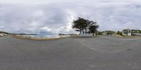 fisheye lens photograph showing a view of the sea and street at low tide of day