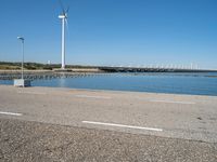 Coastal Road in Holland with Azure Ocean and Windmills