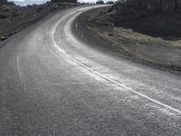 the road is empty and paved on the side of it for people to walk on