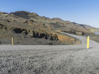 the road is very rocky near the ocean on the side of the mountain range in iceland