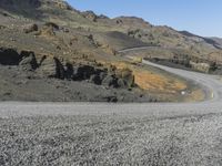 the road is very rocky near the ocean on the side of the mountain range in iceland