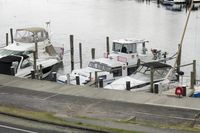 Coastal Road by the Lake: A Scenic View with Boat and Pier