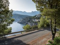 the view down the road to a small village near the water in italy - ©iw