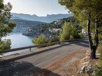 the view down the road to a small village near the water in italy - ©iw