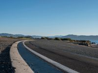 Coastal Road with Low Hills and Ocean View