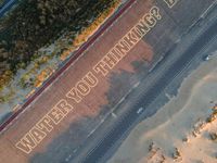 a view of the street from above with the words new zealand lover painted on it